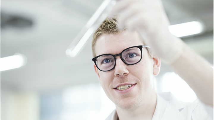 Man looking at a test tube